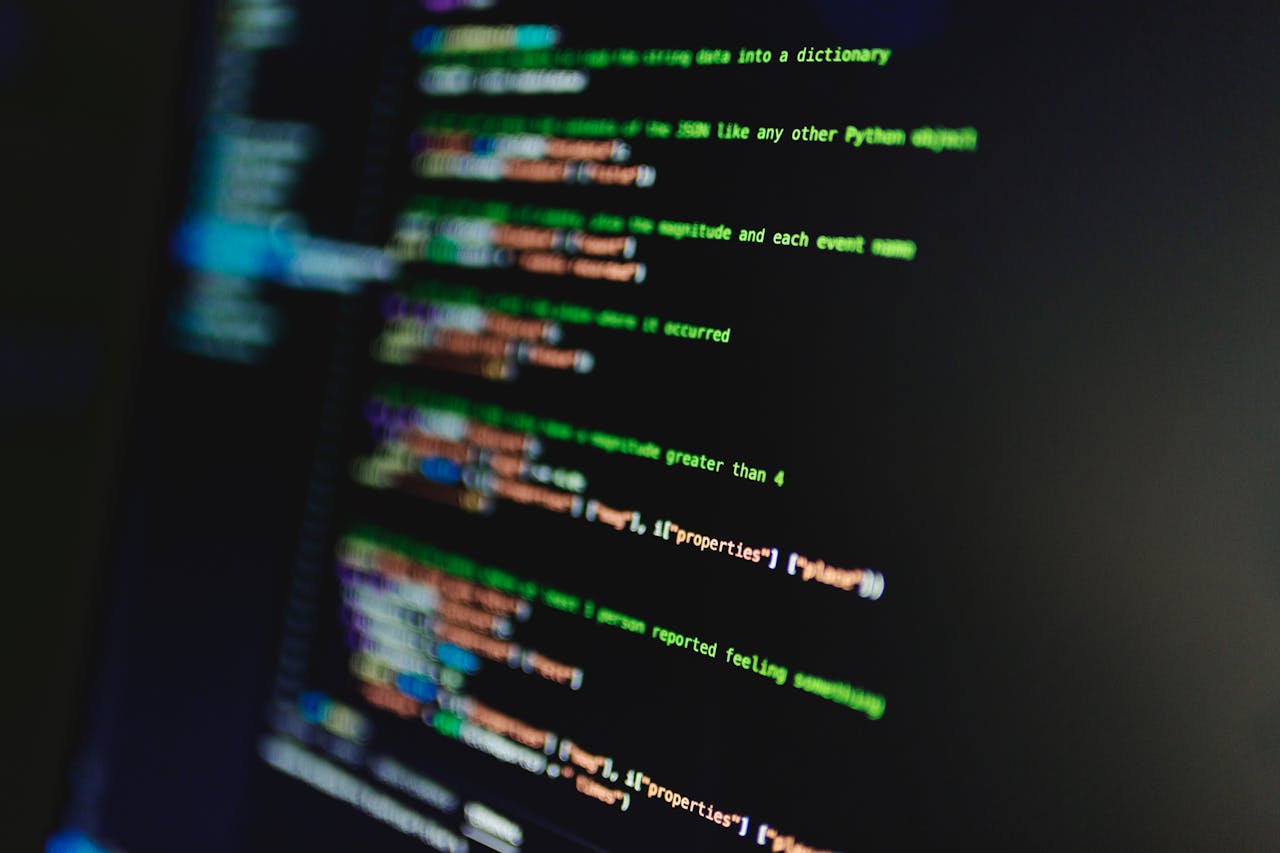 who-we-are Colorful lines of code on a computer screen showcasing programming and technology focus.